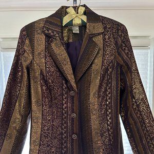 Multi colored blazer with three red and gold jeweled buttons.